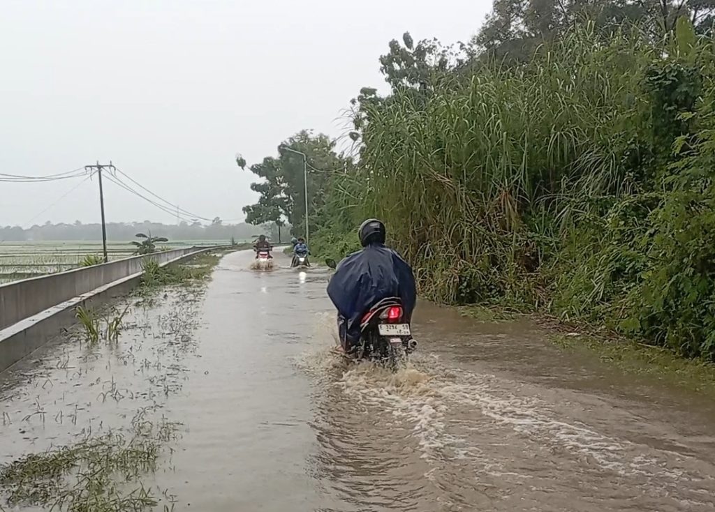 Sedikitnya terlihat tiga sepeda motor terpaksa didorong oleh pemiliknya setelah nekat menerjang genangan air